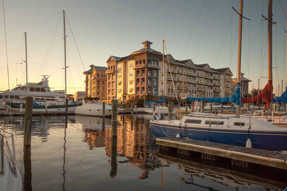 View of multifamily building and marina with boats