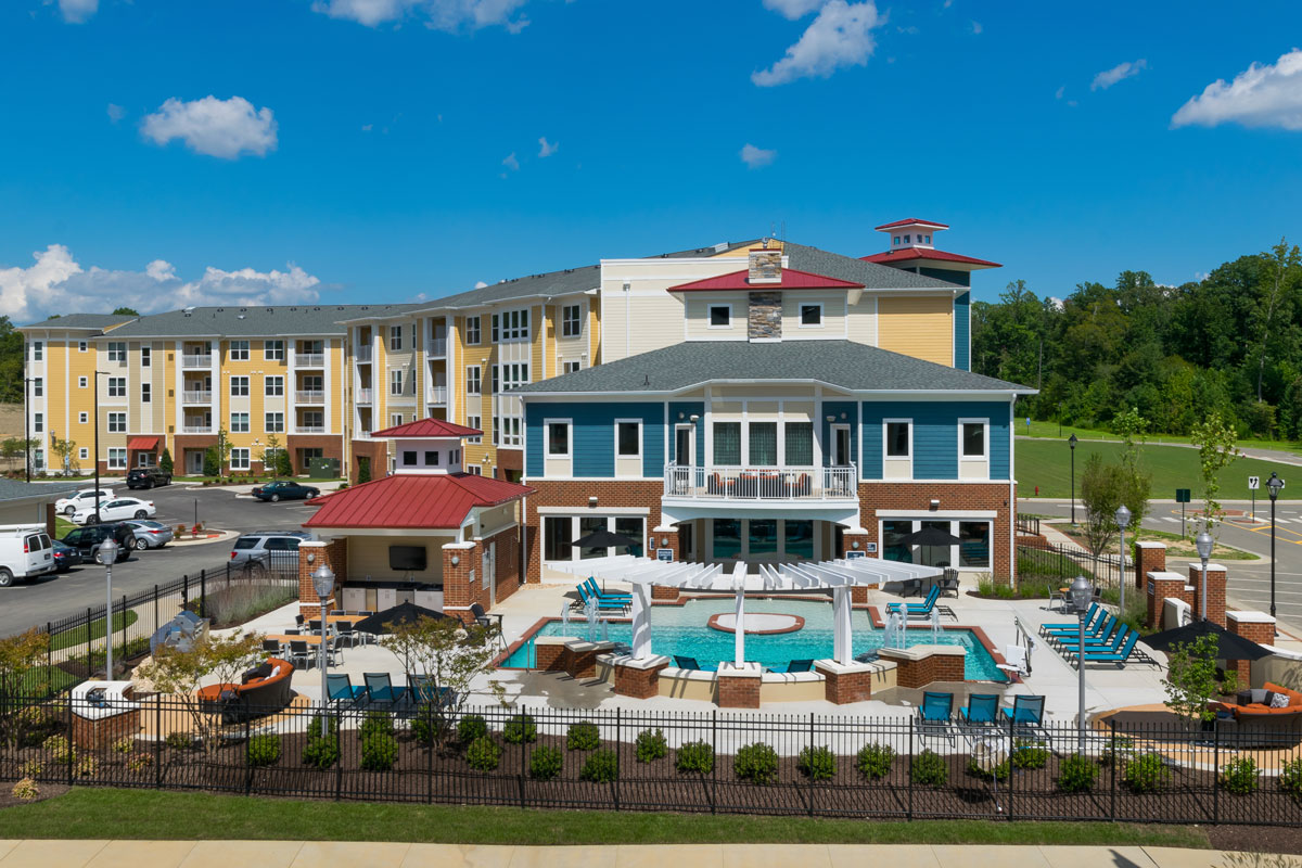 Photo of multifamily building with pool and pool house