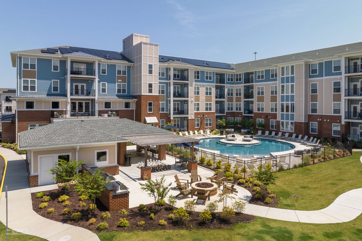 Photo of multifamily building with pool and pool house