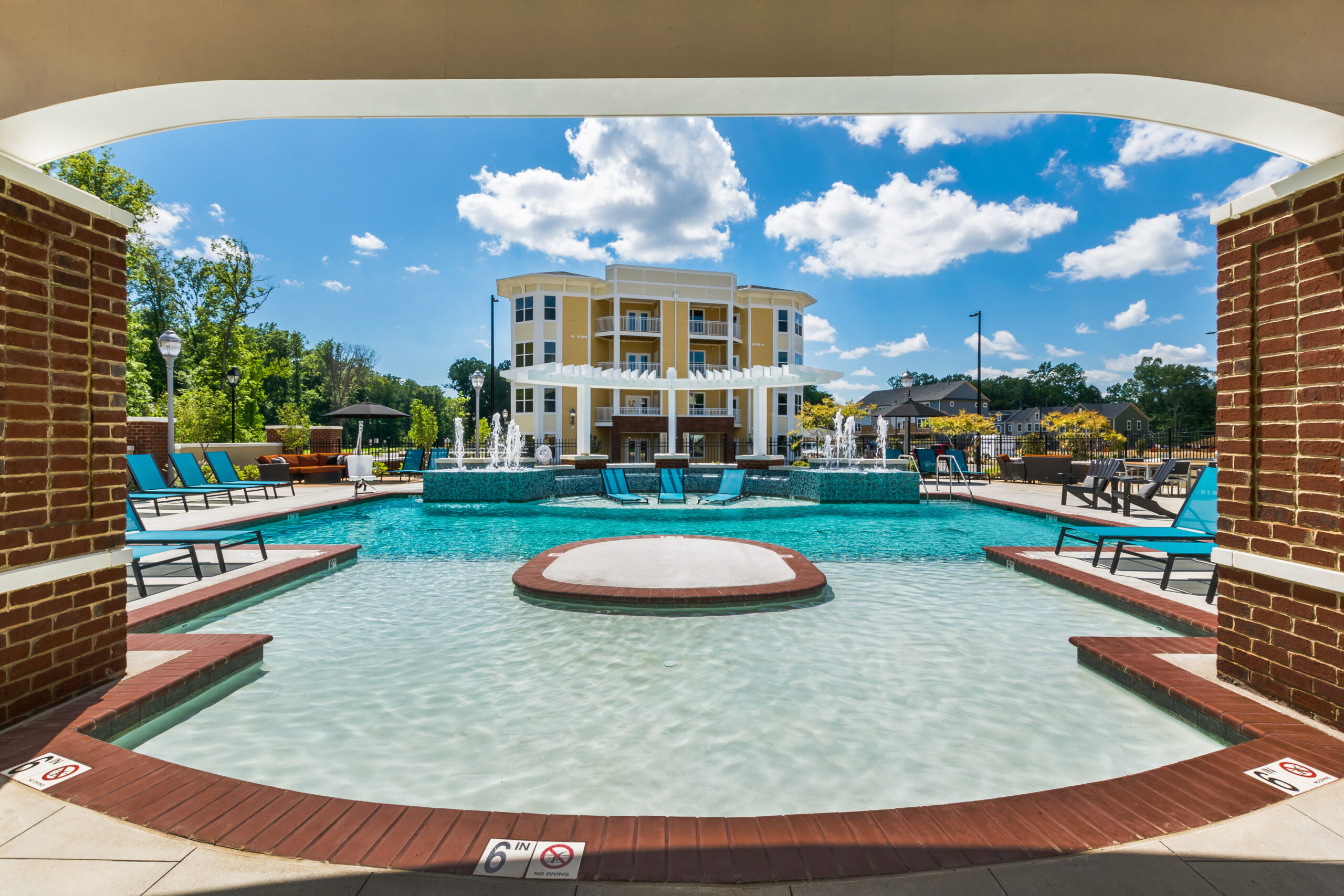 Photo of the pool with multifamily building in the background