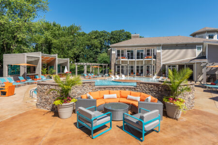 Photo of a pool and the surrounding area with sun chairs and seating